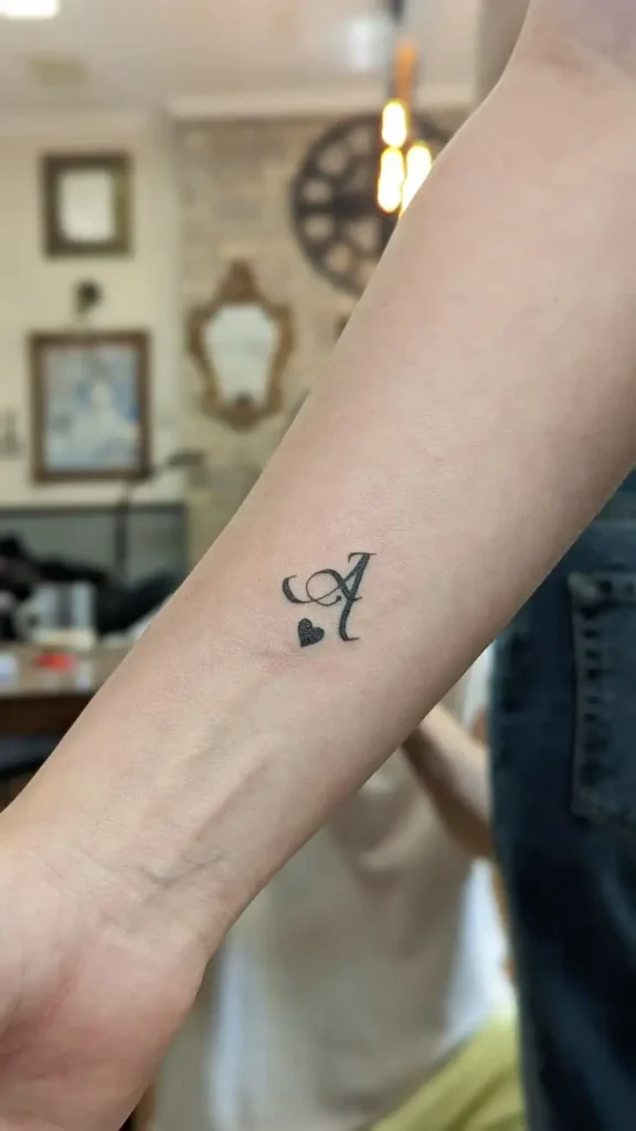 Tatouage de la lettre A avec un cœur en dessous