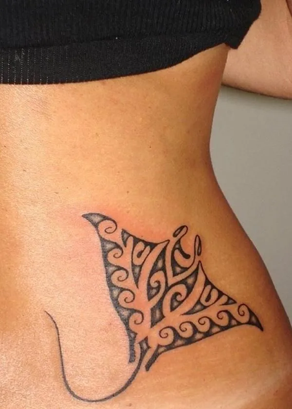 Tatouage raie manta tribal sur la hanche d'une femme