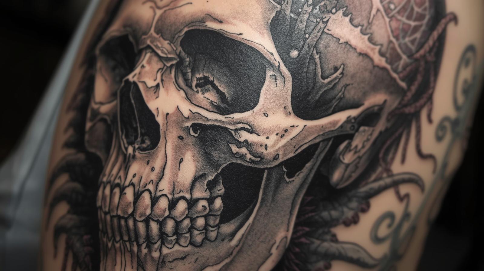 Tatouage de tête de mort sur bras.