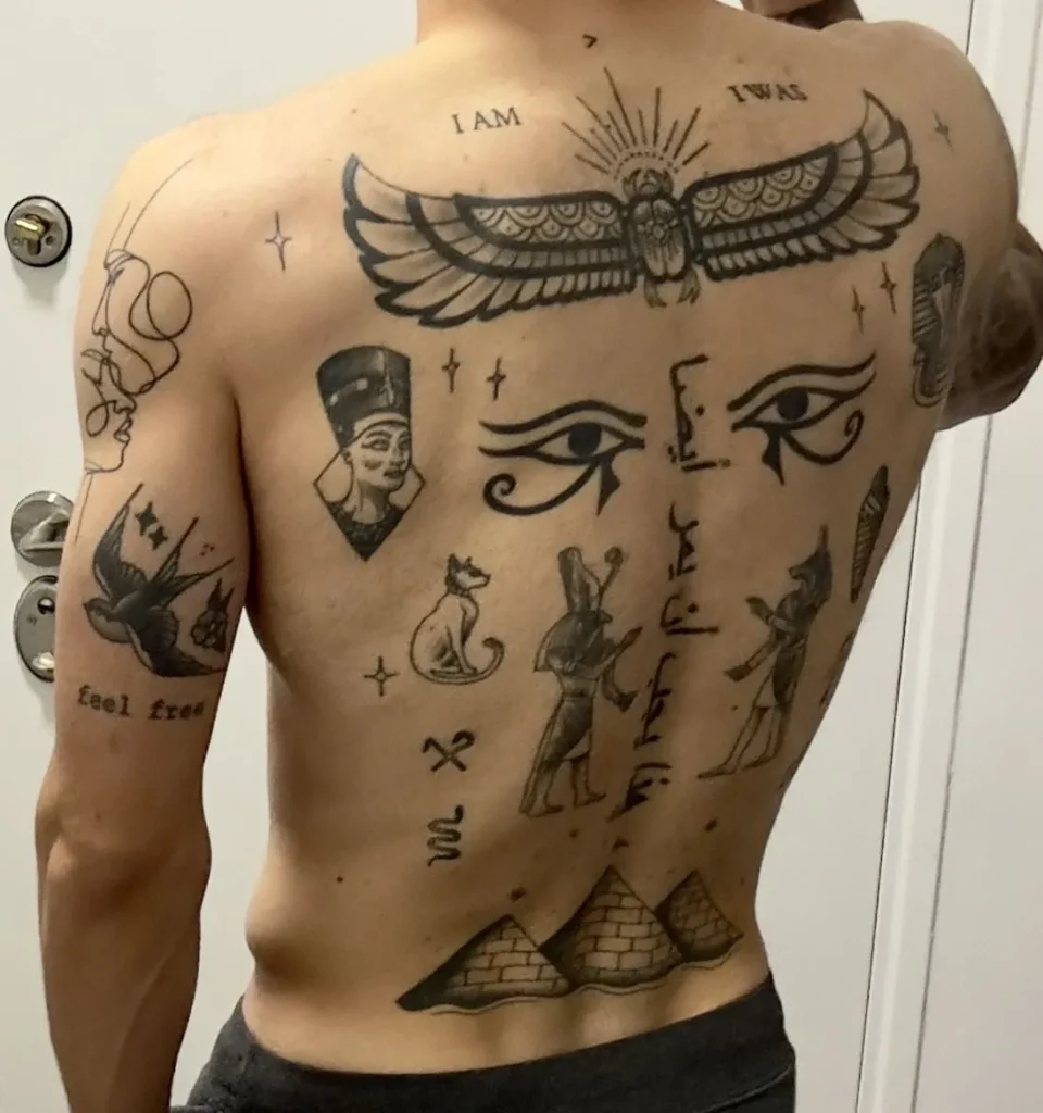 Plusieurs motifs de tatouage égyptien dans le dos d'un homme